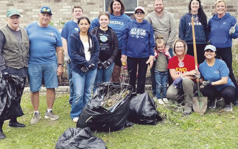 DAY OF SERVICE—Rockdale Rotary Club used their day of service to freshen up the grounds of the MARC Center on Saturday. Shown here in the left-hand photo are (L-R) Rita Johnson, Homer Mowdy, Destinee Bluford, Tiffany Whitsel, Gaye Bland, Nathan Bland, Karis Bland, Maci Wages, Sandy Langwell, Kathryne Roddam and Melissa Barchuch. In the photo on the right, MARC Board member Leslie Davidson, MARC Board President Ann King with Rotarians Melissa Barchuch and Rockdale City Manager Tim Kelty.