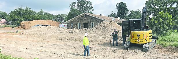 Workers surveying and moving dirt Monday morning at the new Integrity Urgent Care facility in the former Rockdale Veterinary Clinic location at 618 West US 79. The facility is reported to open by the end of this year.