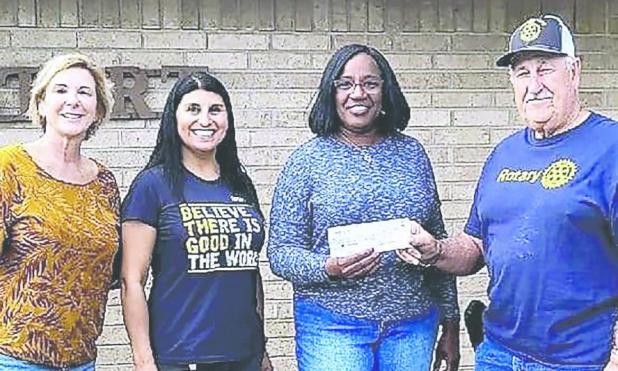 The 22nd annual Community Outreach Thanksgiving Dinner, which will be held Saturday at the First Baptist Church from 11 a.m. to 2 p.m., got a $200 boost from the Rockdale Rotary Club. Shown here (L-R) are Rotary members Gaye Bland, Melissa Barcuch, dinner organizer Pam King and Rotary member Homer Mowdy.
