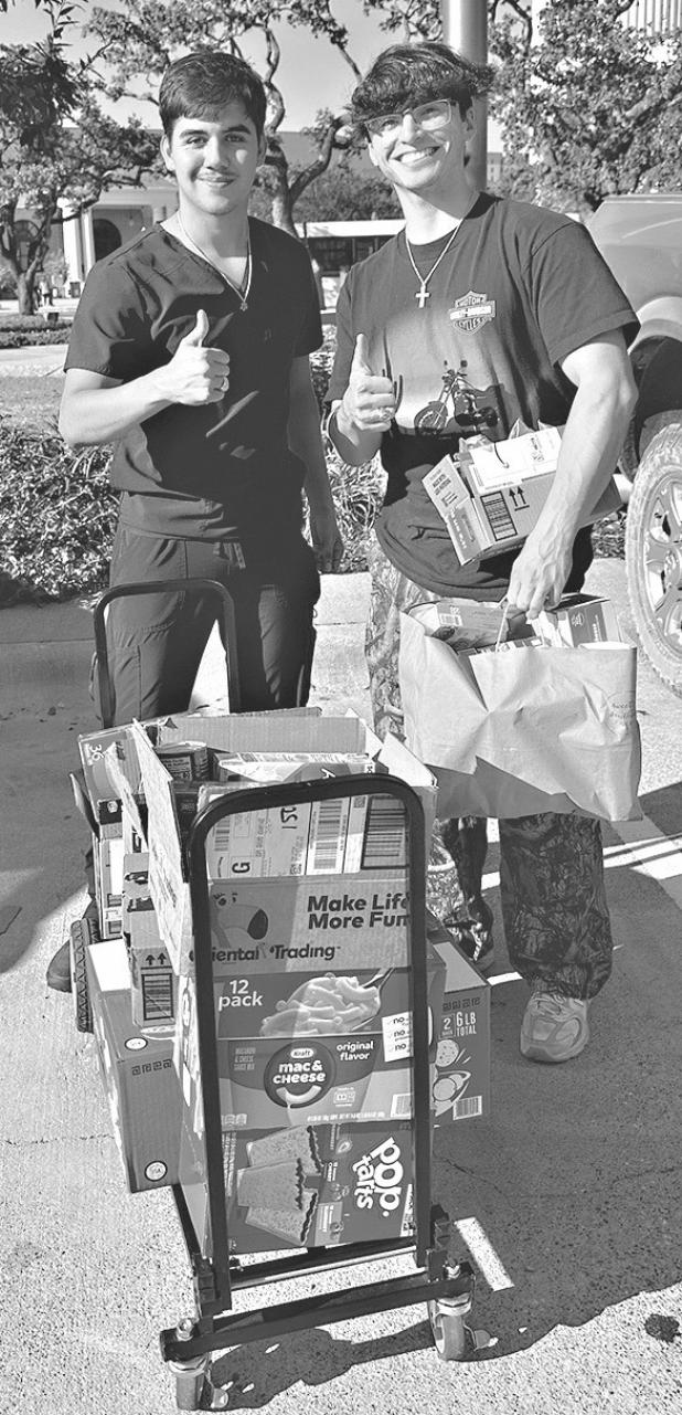 Aggie students help unload donations from Milam County Aggie Moms.