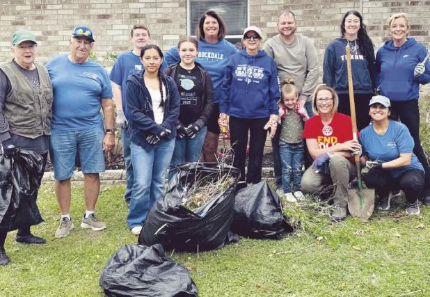 DAY OF SERVICE—Rockdale Rotary Club used their day of service to freshen up the grounds of the MARC Center on Saturday. Shown here in the left-hand photo are (L-R) Rita Johnson, Homer Mowdy, Destinee Bluford, Tiffany Whitsel, Gaye Bland, Nathan Bland, Karis Bland, Maci Wages, Sandy Langwell, Kathryne Roddam and Melissa Barchuch. In the photo on the right, MARC Board member Leslie Davidson, MARC Board President Ann King with Rotarians Melissa Barchuch and Rockdale City Manager Tim Kelty.