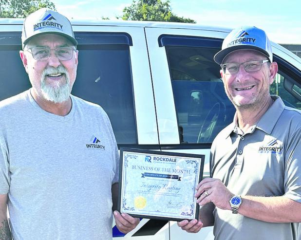 BUSINESS OF THE MONTH— Rockdale Chamber of Commerce has named Integrity Roofing &amp; Constructions LLC the Business of the Month for September. Shown are business partners Clint Cox (L) and John Marshall. Call the company at 512-820-- 0059 for all your roofing and construction projects.