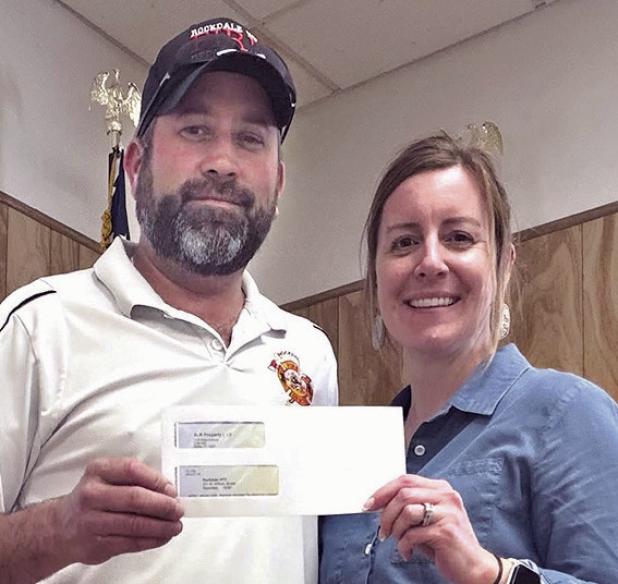 RVFD DONATIONS— Fire Chief James McQuinn accepts a $2,000 donation from Business Systems and Communications Associate Kayla Schnell. The volunteer fire department also recently received $15,000 from Cappolino | Dodd | Krebs LLP, $1,000 from Dale Throckmorton, and $1,500 from Pete and Nancy Zenner.