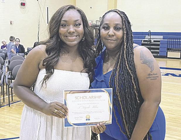 Golden Girls Scholarship T’Niyah Miles receives $1,000 from her mother and Golden Girls coach Vicky Miller.