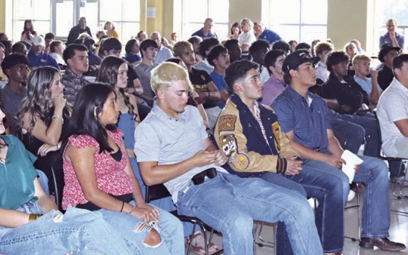 Above, Rockdale student athletes wait to hear their name called during last week’s athletic banquet. At right, Rockdale Athletic Director/Head Football Coach Hunter Hamrick speaking at the banquet. A full list of award winners will be available in next week’s Reporter. Rockdale Tigers Athletics photos