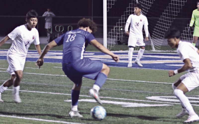 Tiger Wilmer Sorto (18) gets through defenders on Friday night at Tiger Stadium. Sorto scored three of the Tigers four goals in their 4-2 victory of the Yoemen. Reporter/Nathan Flores