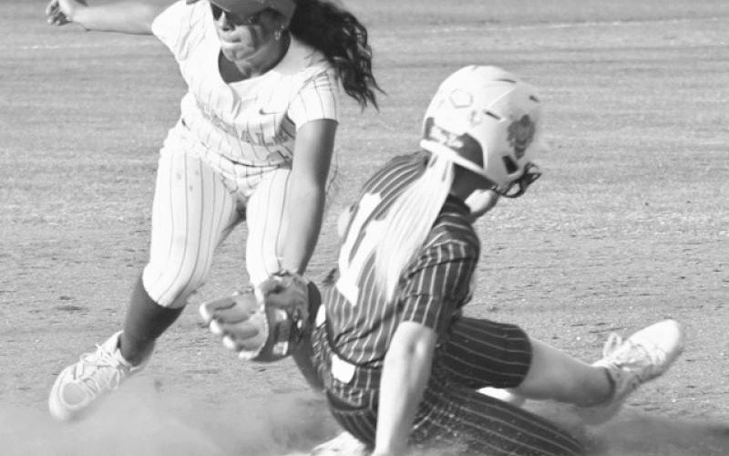 Above, Tiger catcher Kade Lillard denies the Bees from crossing the plate in Thursday game. The Tigers won, 1-0. At right, Lady Tiger Lexi Garcia puts a tag on a Lady Bee’s runner in Thursday’s game. Reporter photos by Nathan Flores