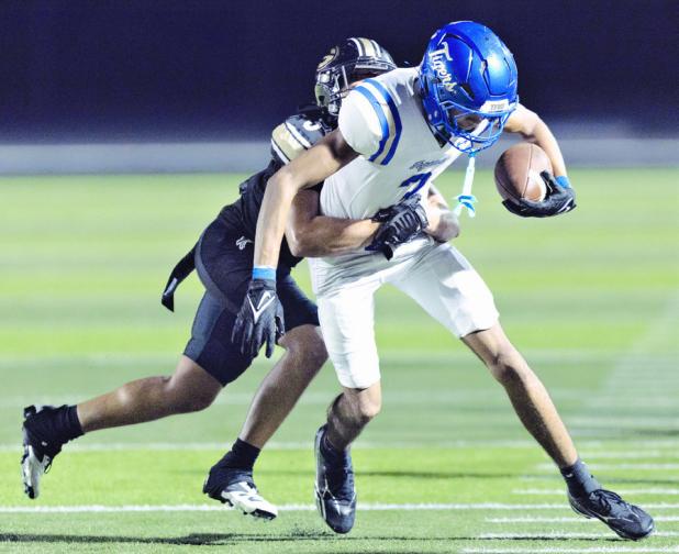 Tiger receiver Jon Fuller hauls in a pass on Friday night against the Giddings’ defense. Fuller had the lone Tiger touchdown on Friday night. Photo by Steve Young