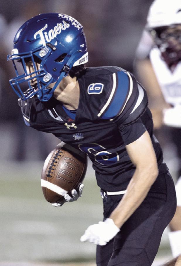 Tiger wide receiver Cohen Razo (6) gets loose on a 39-yard reception Friday in the Battle of the Bell game at Tiger Stadium.