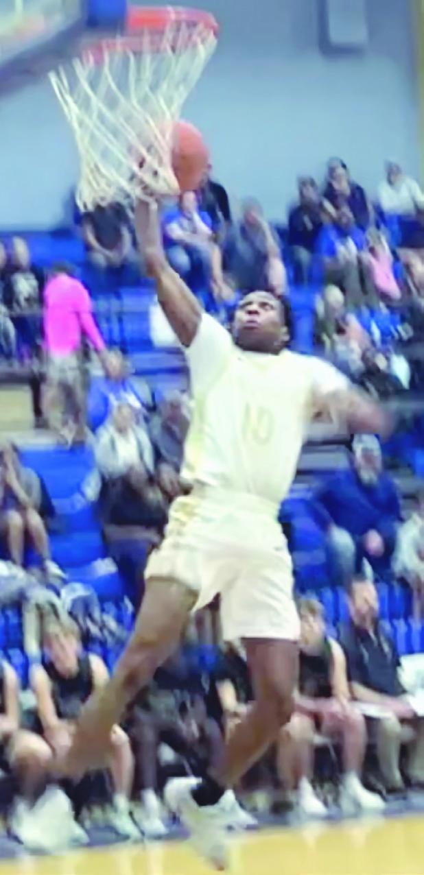 At right, Tiger De’Andre Stephens goes up for a dunk against Franklin Friday night in Tiger Gym. Stephens ended the night with 9 points for the Tigers in their 75-45 victory. Photo extracted from a video by Destin Richardson