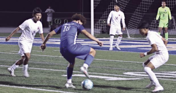 Tiger Wilmer Sorto (18) gets through defenders on Friday night at Tiger Stadium. Sorto scored three of the Tigers four goals in their 4-2 victory of the Yoemen. Reporter/Nathan Flores