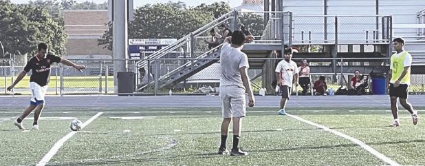 Some locals take advantage of the field and a warm Sunday evening to play soccer. Reporter/Ken Ansell
