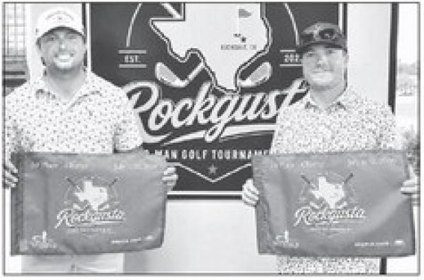 Champ Flight winners Tucker Tovar (left) and Jakob Mikel display their championship flags after winning the top flight at the fourth annual Rockgusta Two-Man Scramble, held July 11-12 at the Rockdale Country Club. The tournament attracted 55 teams competing across five flights. Rockdale Country Club photos