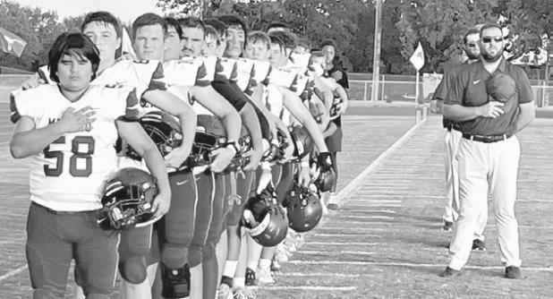 The Milano Eagles line up for the national anthem before Friday night’s game in Axtell. Milano High School photo