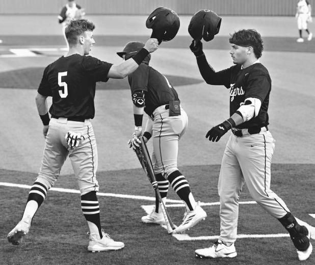 Tiger Brody Willard (R) is congratulated by Mason Lillard (5) after hitting a solo home run in the first inning against Thrall in last Tuesday's game. Rockdale would go on to win game one of the series, 11-1. Photo by Ashley Zenner Willard
