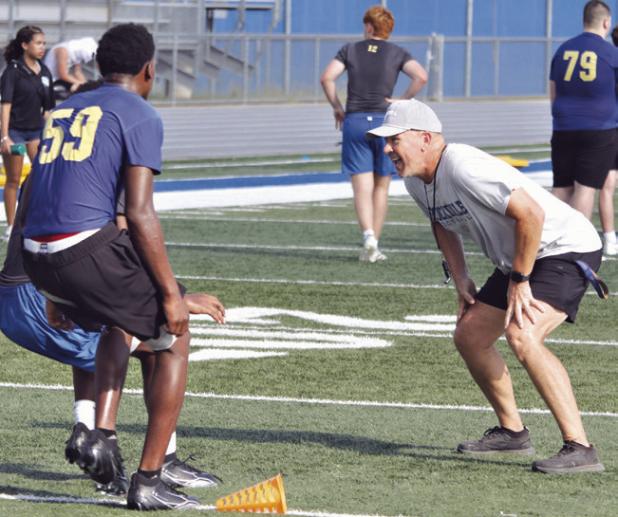 Coach Brent Hasselbach shares his coaching experience with Tiger players during Saturday morning practice at Tiger Stadium. Reporter photo by Nathan Flores