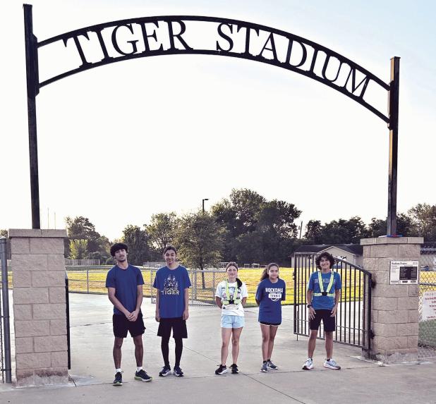 Rockdale High School cross country runners gather at the Tiger Stadium entrance before the first practice of the 2026 season Monday morning. The five runners attending the opening workout were (L-R) Emiliano Tovar, Taiyari Hernandez, Victoria Zeintek, Angelique N ieto and Amador Baggerly.