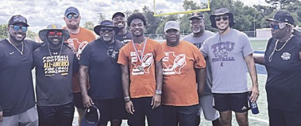 FIT 22 MVPs— Treyvion Miles (above, with coaches) was named the high school MVP in last week’s annual Fit 22 Football Clinic, while Drew Hamilton (below, with coaches) claimed MVP honors for the junior high division. Reporter photos by Ken Ansell