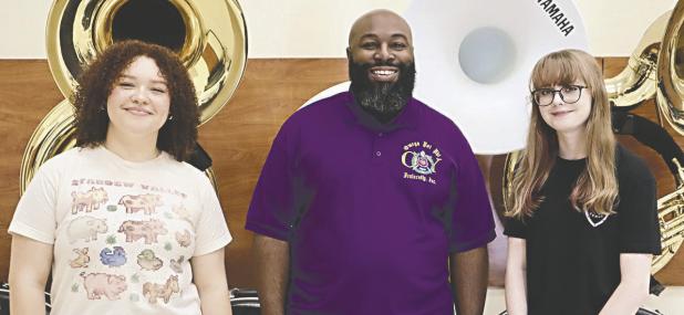MEET THE BAND DIRECTOR— About 60 people welcomed new band director Samuel W. Long, Jr. on Monday night at RHS. Long is shown here with students Destinee Bluford (left) and Annabelle Henderson.