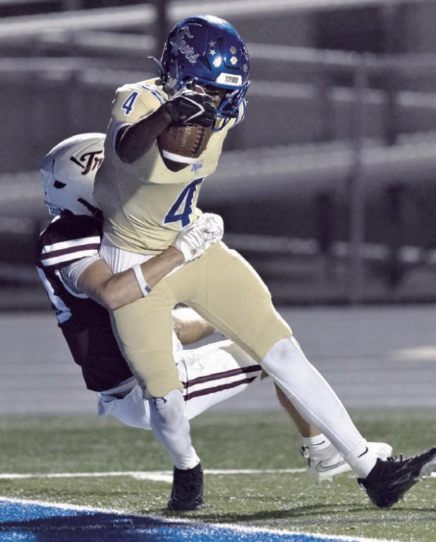 Rockdale receiver Kendrick Henderson hauls in the only touchdown for the Tigers on Friday night. Photo by Steve Young