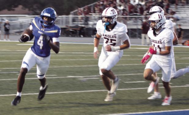 Rockdale receiver Kendrick Henderson (4) evades the Eagle defense on his way to a touchdown. Henderson led the Tigers Friday with three touchdowns on the night. Reporter/Nathan Flores