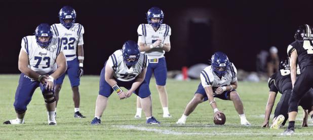 Photo by Steve Young The Tiger offense, led by quarterback Greyson Williams (7), lines up for a play Friday night against the Rogers Eagles at Merk Field. The Eagles claimed their first victory over Rockdale since 1944’s 6-0 win.