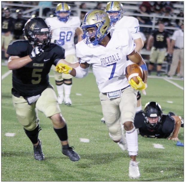 ‘Dogs bite Tigers in district opener