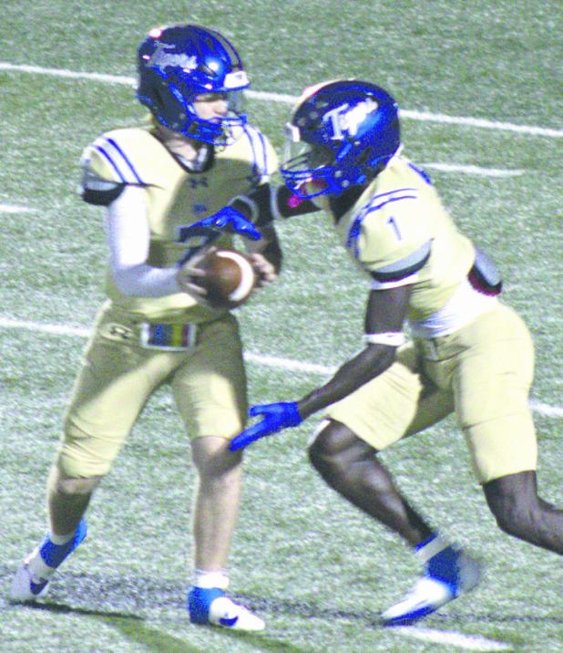 Tiger QB Greyson Williams (7) hands off to RB Jeramiah Butler (1) Friday against the highly-ranked Lexington Eagles. Butler had 12 carries for 42 yards on the night. The Eagles handed Rockdale their first loss of the season, 33-7, in Tiger Stadium. Photo by Stacy Henderson