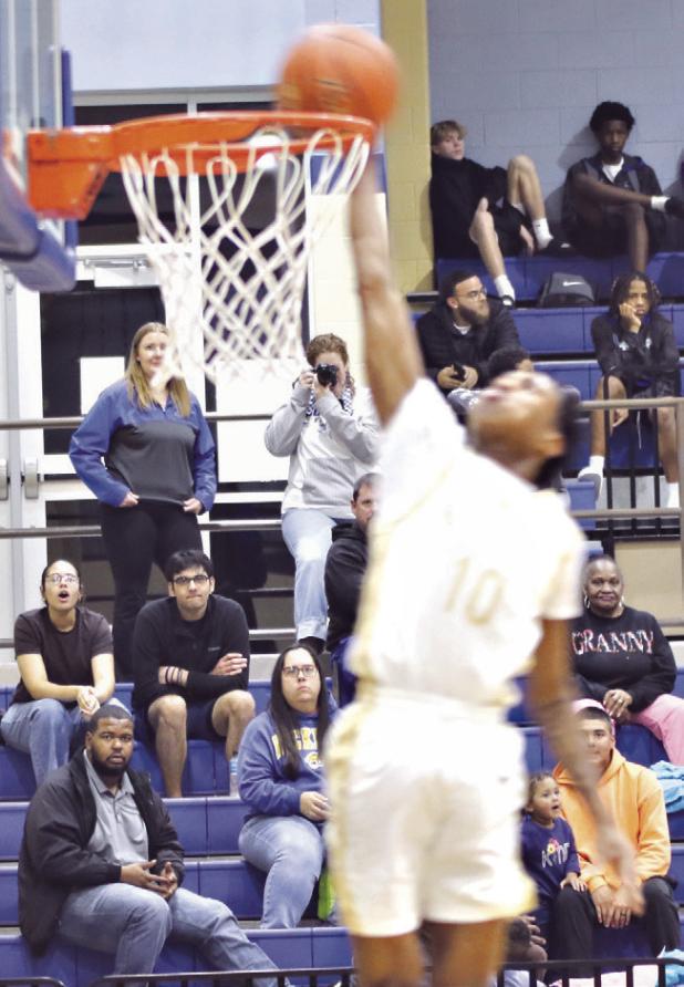 Tiger standout senior De’Andre Stephens (L) goes up for a dunk Tuesday night against the rival Cameron Yoe in Tiger Gym. Stephens reached a career milestone, surpassing Reporter/Nathan Flores