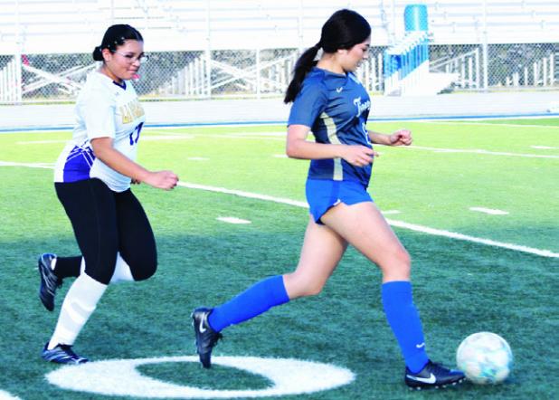 Rockdale Lady Tiger Lilly Matula is pursued downfield last week in the soccer match against La Grange at Tiger Stadium. Rockdale lost the game, 2-0. Reporter/Nathan Flores