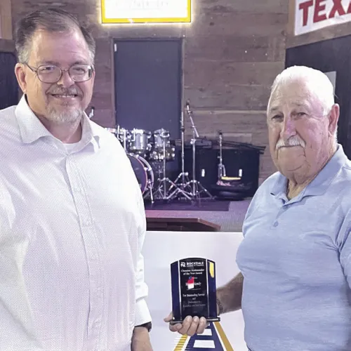 Homer Mowdy accepts Chamber Ambassador of the Year from Tim Kelty.