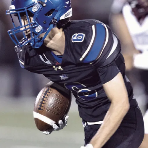 Tiger wide receiver Cohen Razo (6) gets loose on a 39-yard reception Friday in the Battle of the Bell game at Tiger Stadium.