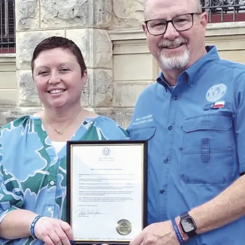 PROCLAMATION— Milam County Judge Bill Whitmire read declared April as Child Abuse Awareness Month on the courthouse lawn on Friday, April 17 at 9 a.m. Whitmire is shown here with CASA Executive Director Rachel Owens.