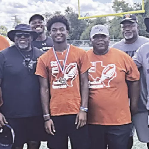 FIT 22 MVPs— Treyvion Miles (above, with coaches) was named the high school MVP in last week’s annual Fit 22 Football Clinic, while Drew Hamilton (below, with coaches) claimed MVP honors for the junior high division. Reporter photos by Ken Ansell