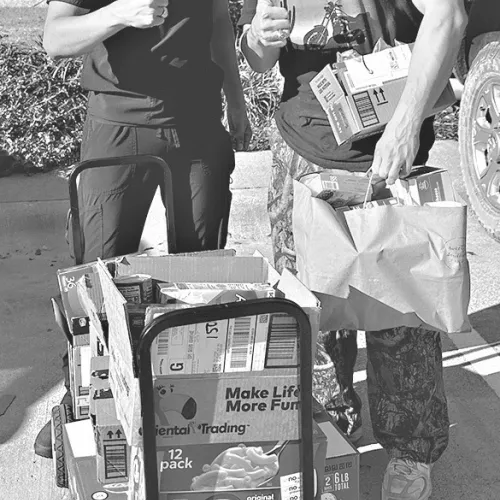 Aggie students help unload donations from Milam County Aggie Moms.