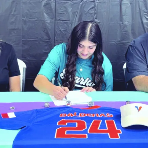 COMMITTED— Milano High School senior Marissa Balderas (center) recently signed to continue her softball career at Southeast Arkansas College, as her mother and father, Shanna and J.R. Balderas, look on. Submitted photo