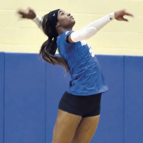 Rockdale Lady Tiger Chloe Miles serving against Academy on Friday in Tiger Gym. Miles led the Lady Tigers with seven digs, four kills and five assists. Rockdale lost to Academy in three straight sets— 10-25, 17-25 and 11-25. Reporter photo by Nathan Flores