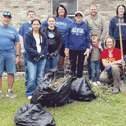 DAY OF SERVICE—Rockdale Rotary Club used their day of service to freshen up the grounds of the MARC Center on Saturday. Shown here in the left-hand photo are (L-R) Rita Johnson, Homer Mowdy, Destinee Bluford, Tiffany Whitsel, Gaye Bland, Nathan Bland, Karis Bland, Maci Wages, Sandy Langwell, Kathryne Roddam and Melissa Barchuch. In the photo on the right, MARC Board member Leslie Davidson, MARC Board President Ann King with Rotarians Melissa Barchuch and Rockdale City Manager Tim Kelty.