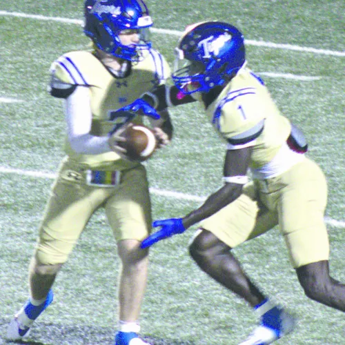 Tiger QB Greyson Williams (7) hands off to RB Jeramiah Butler (1) Friday against the highly-ranked Lexington Eagles. Butler had 12 carries for 42 yards on the night. The Eagles handed Rockdale their first loss of the season, 33-7, in Tiger Stadium. Photo by Stacy Henderson