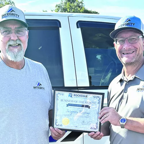 BUSINESS OF THE MONTH— Rockdale Chamber of Commerce has named Integrity Roofing &amp; Constructions LLC the Business of the Month for September. Shown are business partners Clint Cox (L) and John Marshall. Call the company at 512-820-- 0059 for all your roofing and construction projects.