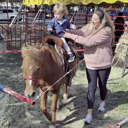NEW ATTRACTION— A petting zoo and pony rides were a big hit with fair-goers over the weekend. The petting zoo had plenty of goats as well as a camel and a kangaroo.