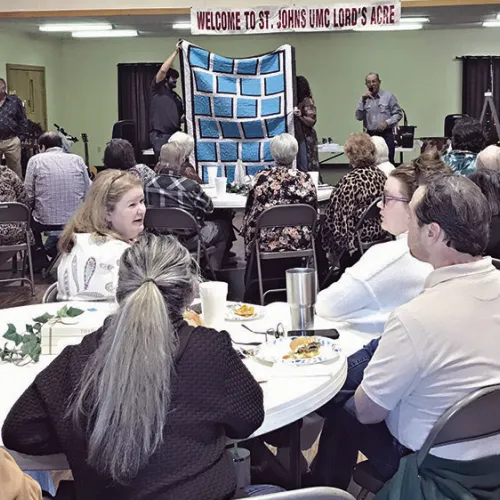FUN TIMES— St. John’s United Methodist Church held their annual fundraiser, Lord’s Acre, on Sunday after church with a meal cooked by the Methodist Men. There was both a live and a silent auction. Auctioneer John Fisher has volunteered his services every year since the fundraiser started in 1997. This year the church raised $22,000 auctioning paintings, Christmas décor, trips, baked goods, dinners, jewelry and more.