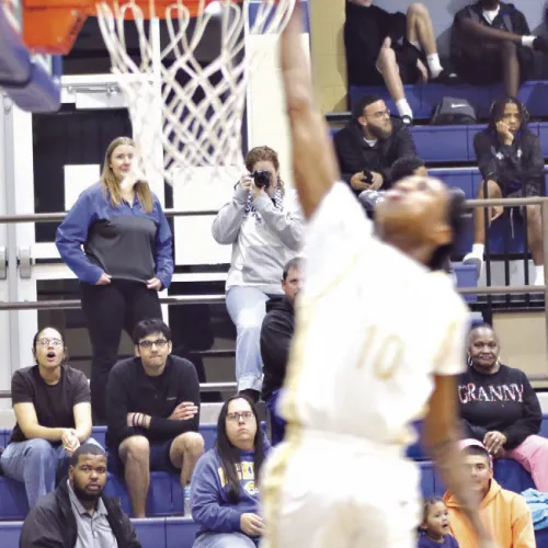 Tiger standout senior De’Andre Stephens (L) goes up for a dunk Tuesday night against the rival Cameron Yoe in Tiger Gym. Stephens reached a career milestone, surpassing Reporter/Nathan Flores